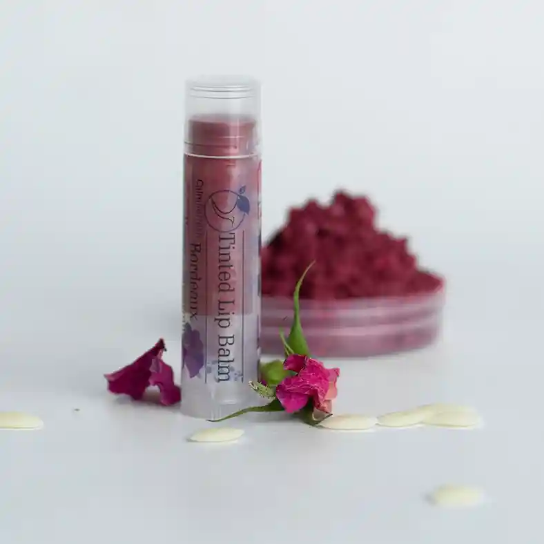 Bordeaux lip balm with mica powder behind it