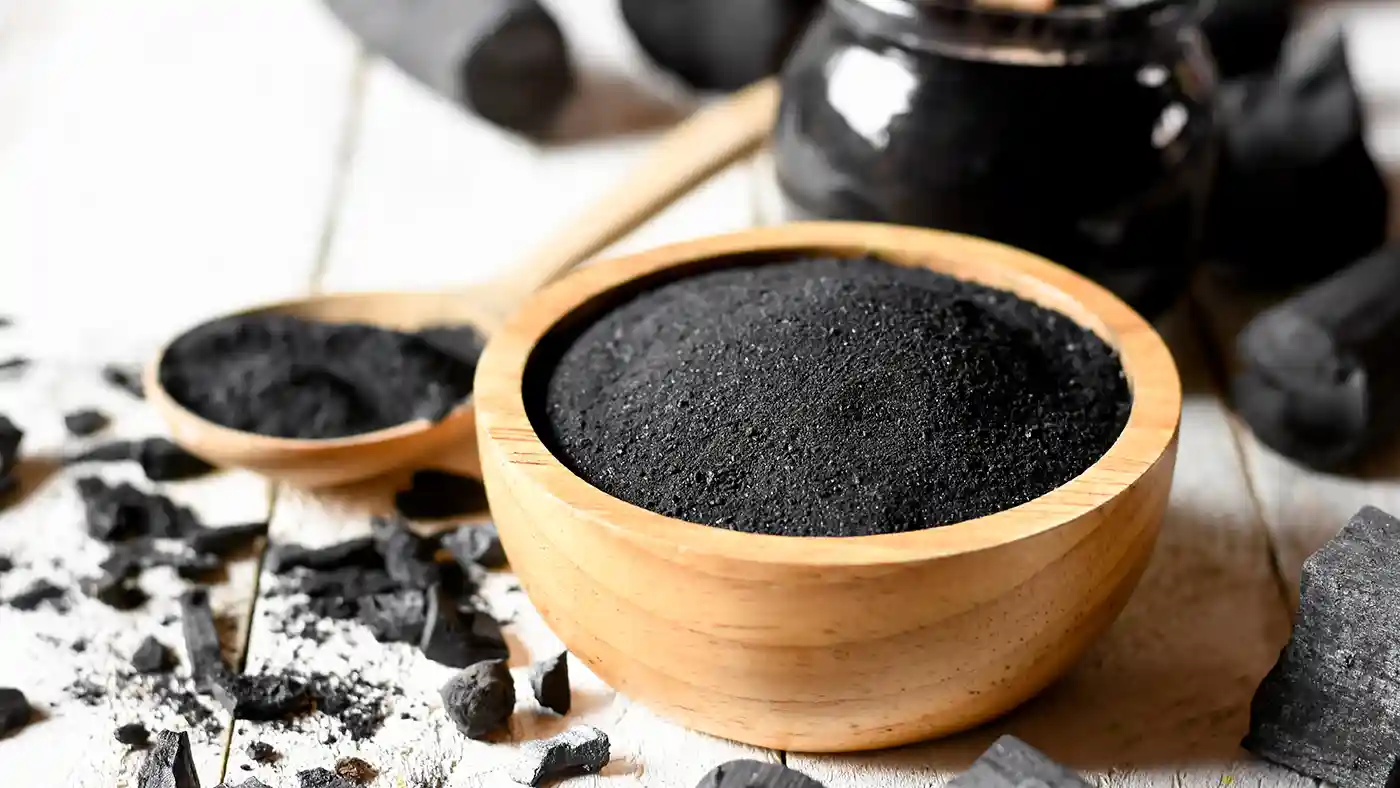 Charcoal powder in wooden bowl