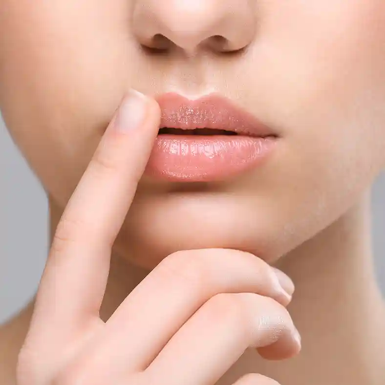 Lady touching lip with finger