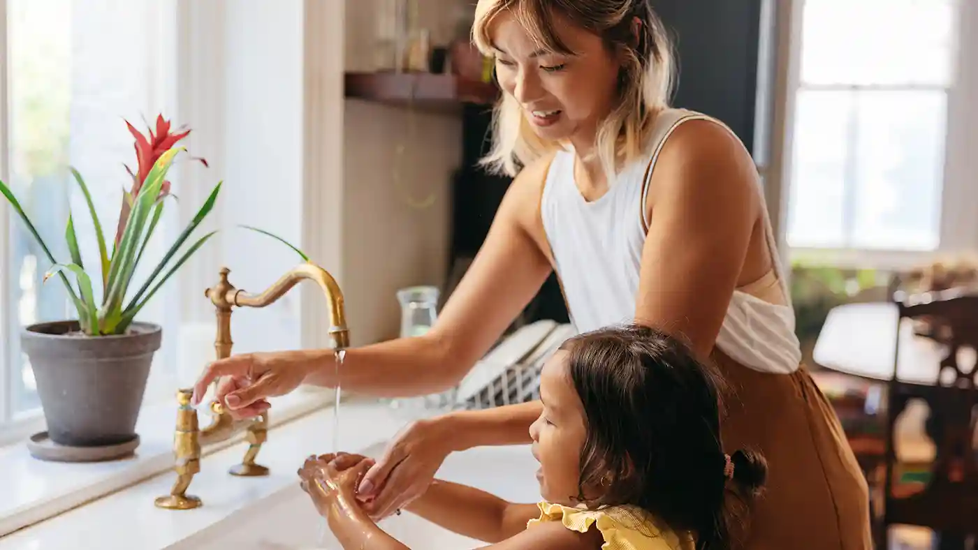 Mother and daughter washing hands