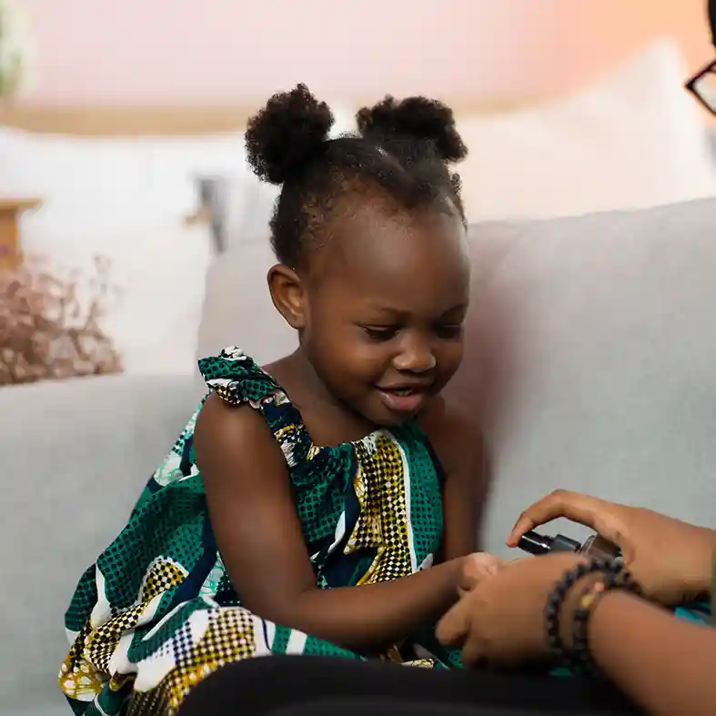 Mother sanitizing daughters hands