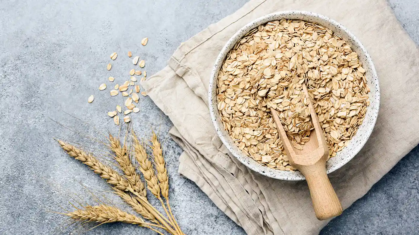 Oat flakes in a bowl on linen serviette