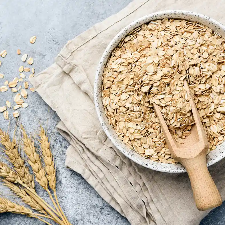 Oat flakes in a bowl on linen serviette