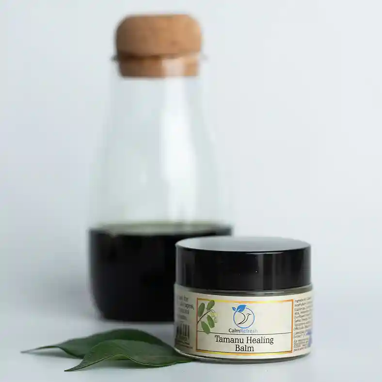 Tamanu Healing Balm with Tamanu Oil in bottle behind to the left