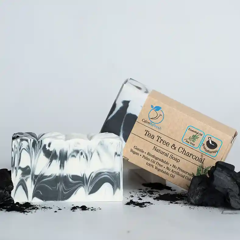 Tea Tree and Charcoal Soap with box and charcoal powder on both sides