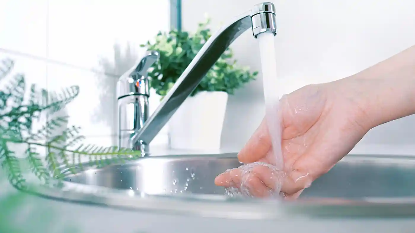 Washing hand under tap