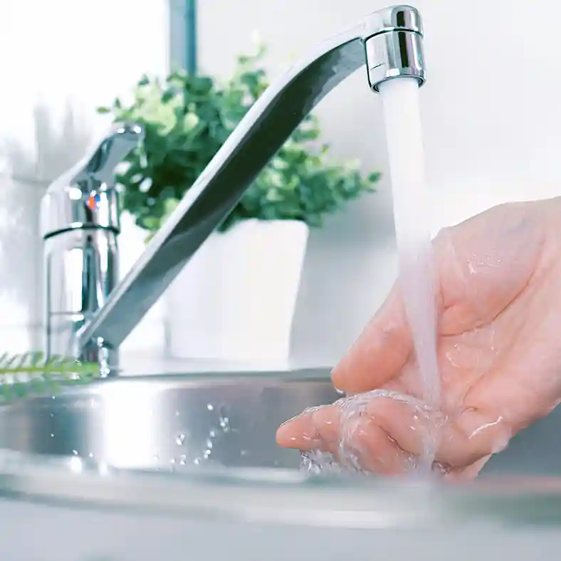 Washiing hand under tap